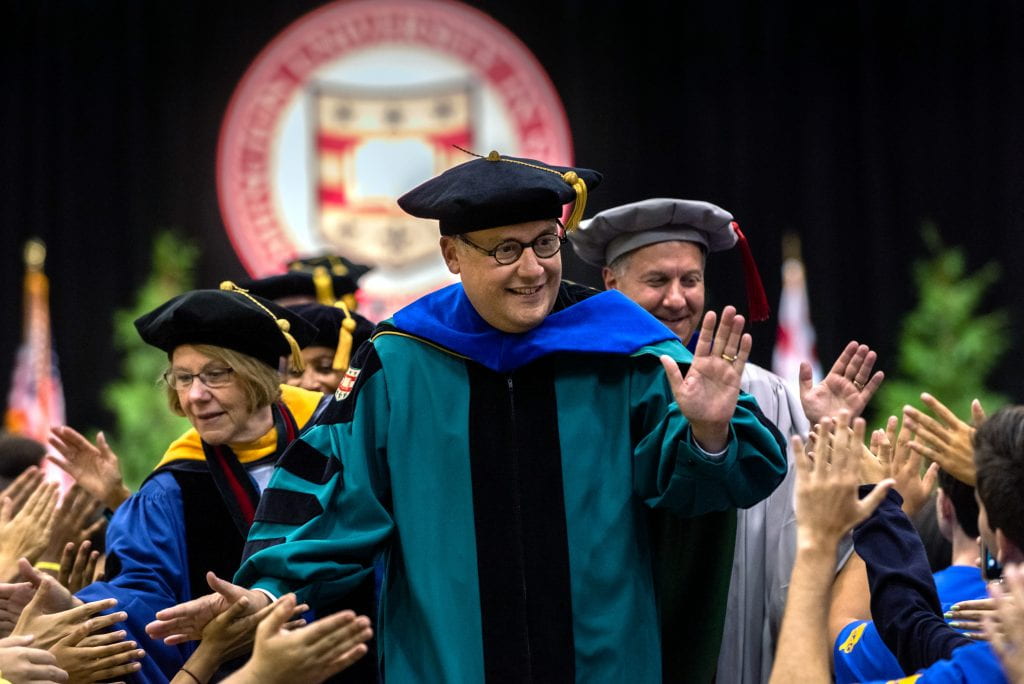 Chancellor Andrew D. Martin (center), joins Barbara Schaal (left), Dean of the Faculty of Arts & Sciences and Aaron Bobick, Dean of the McKelvey School of Engineering, in greeting students during the recessional at the conclusion of Convocation.