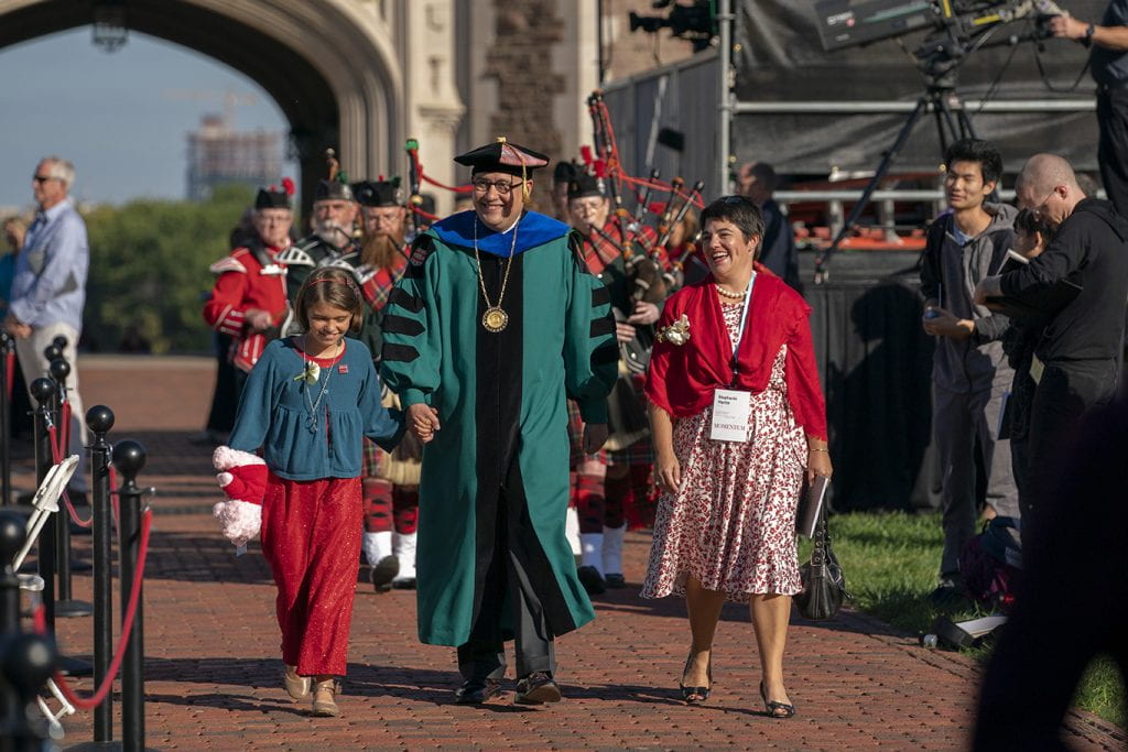 Andrew D. Martin walking through the Brookings Quad with Stephanie and Olive Martin